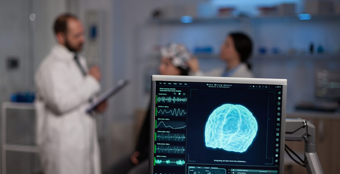 neuroscience doctor holding clipboard showing treatment with neurofeedback